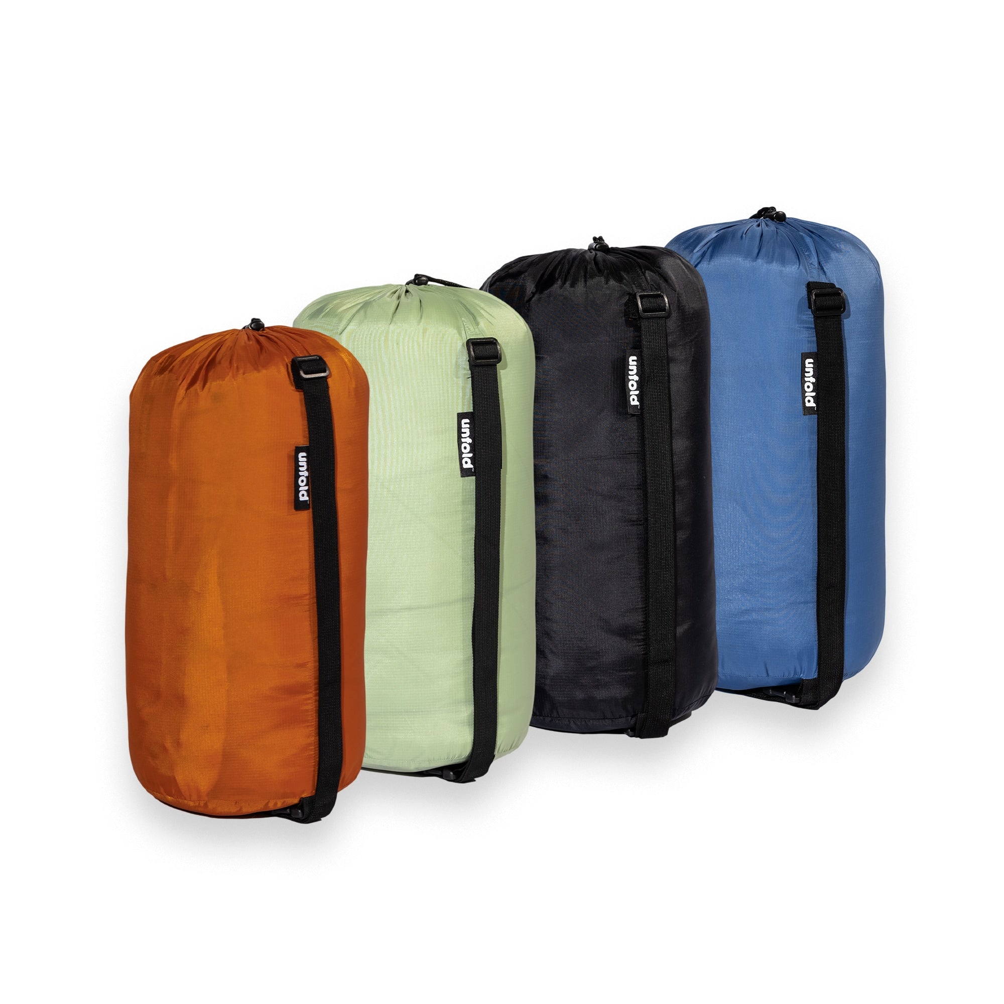 Packsäcke der UNFOLD Reisedecken in Rost, Salbei, Schwert und Blau